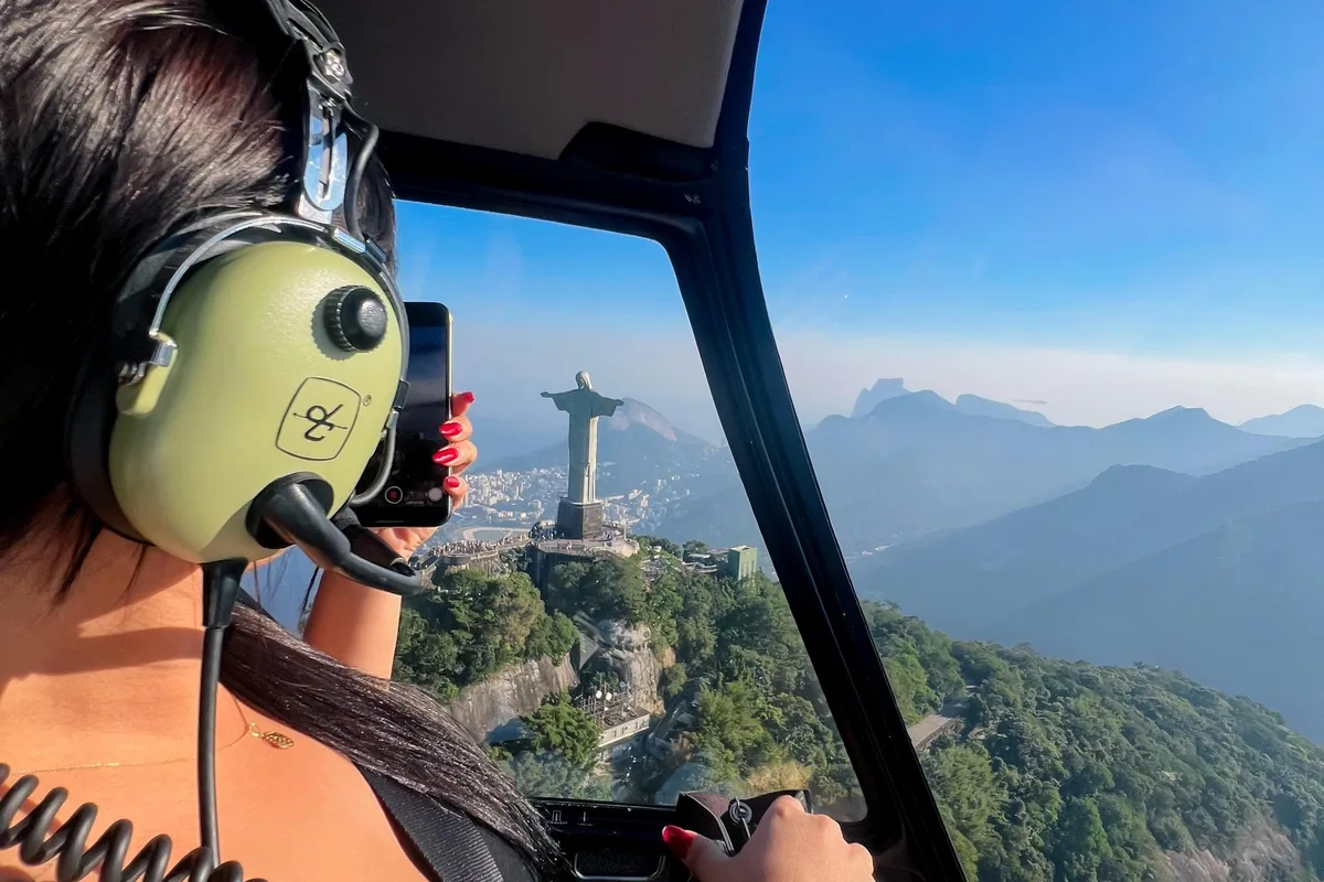 Christ the Redeemer and the Rio coastline seen from a doors off helicopter flight Rio de Janeiro